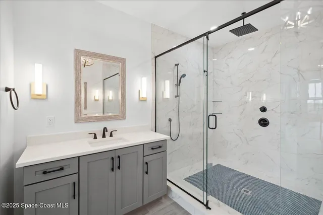a spacious bathroom with a double vanity sink a mirror and a shower