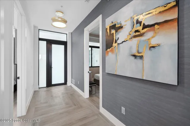 a kitchen with stainless steel appliances granite countertop a stove a sink dishwasher and a refrigerator with wooden floor