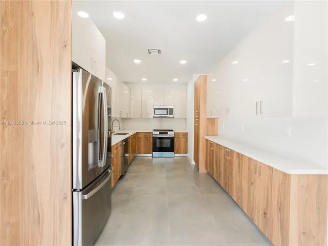 a view of a kitchen with a refrigerator and a stove