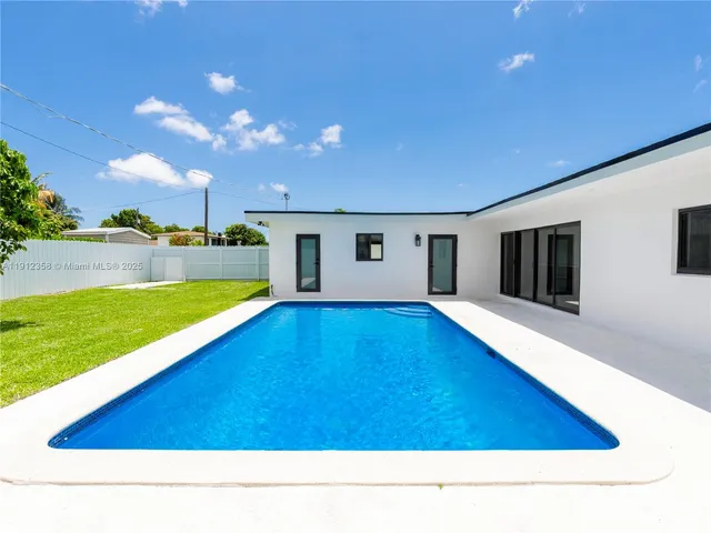 a swimming pool with outdoor seating and yard