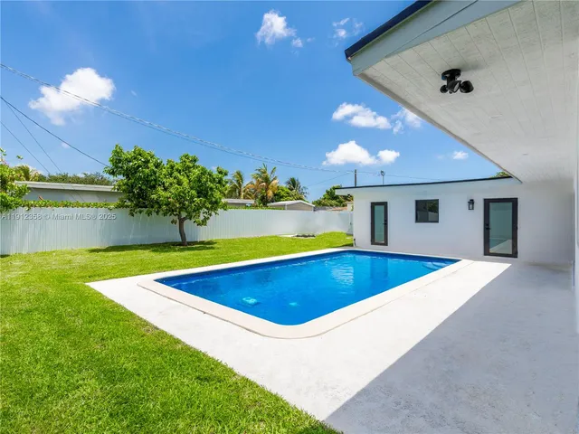 an empty room with windows and entrance