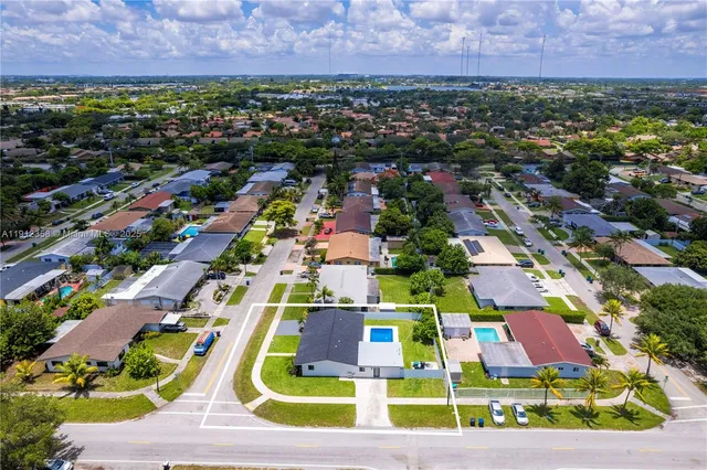 an aerial view of multiple houses with yard