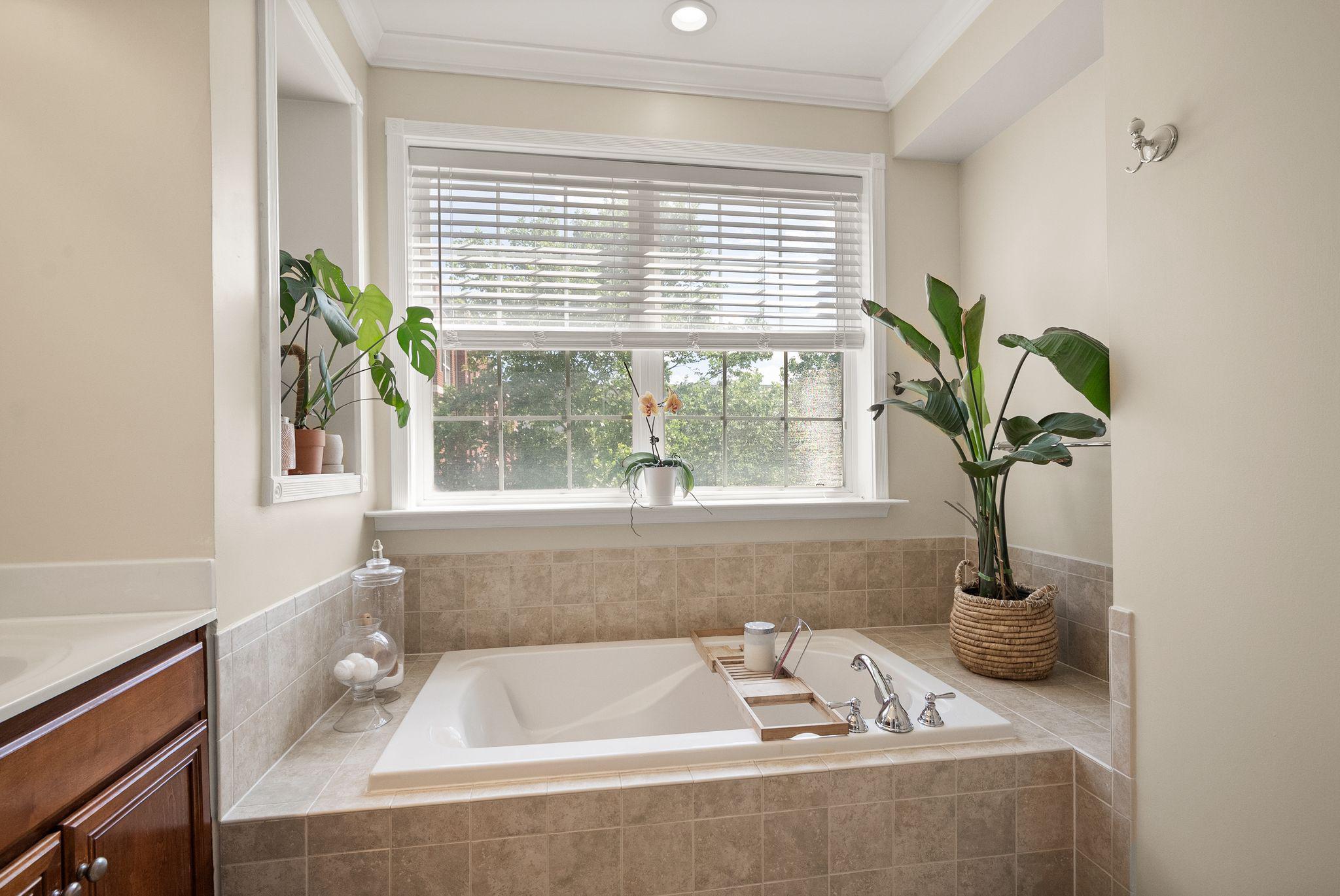 12414 A Liberty Bridge Road Fairfax, VA 22033 - Photo 22 of 38 a bath tub sitting in a bathroom next to a window
