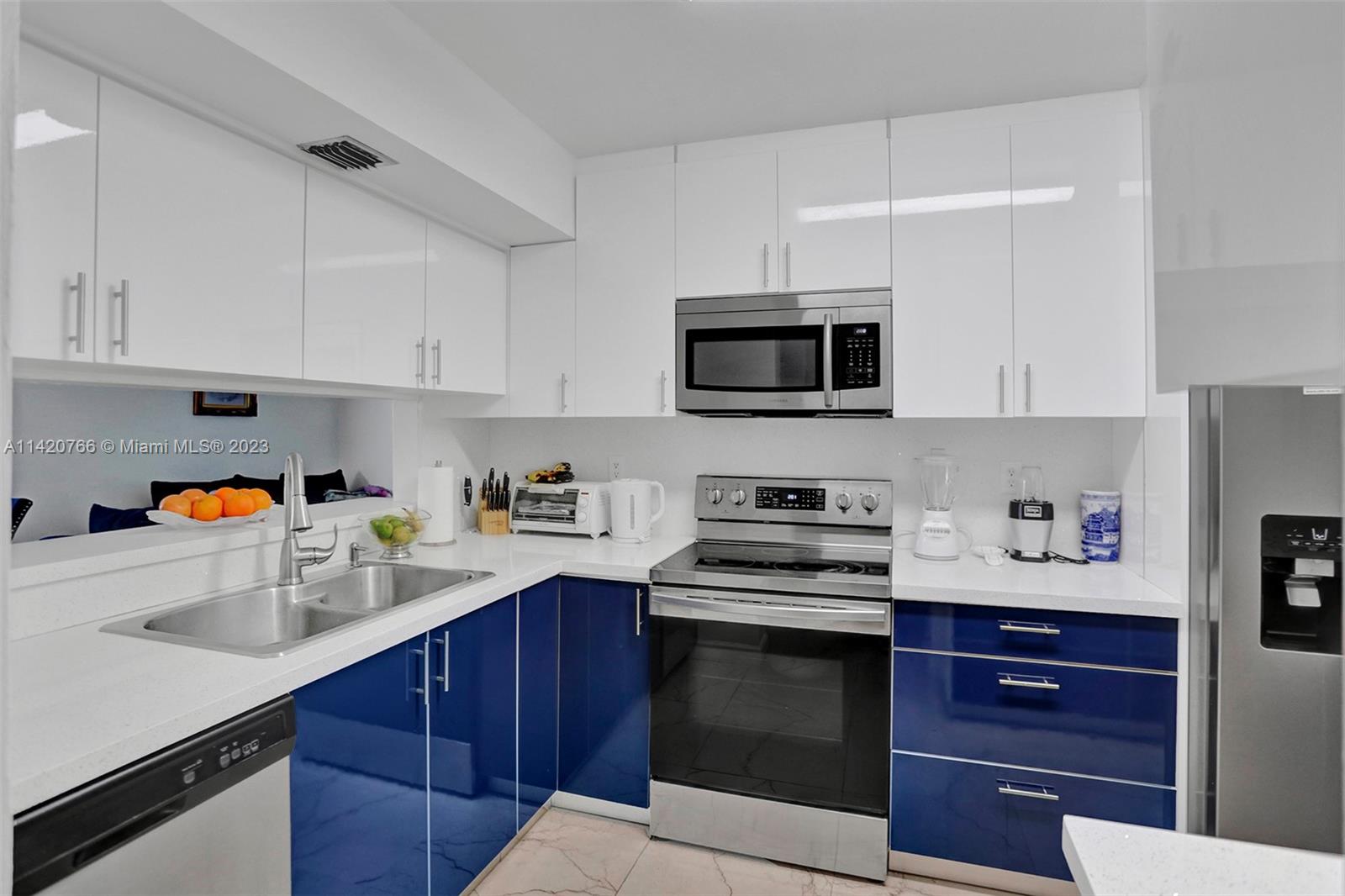 3410 Foxcroft Road, Unit 202 Miramar, FL 33025 - Photo 1 of 35 a kitchen with a sink stove and microwave