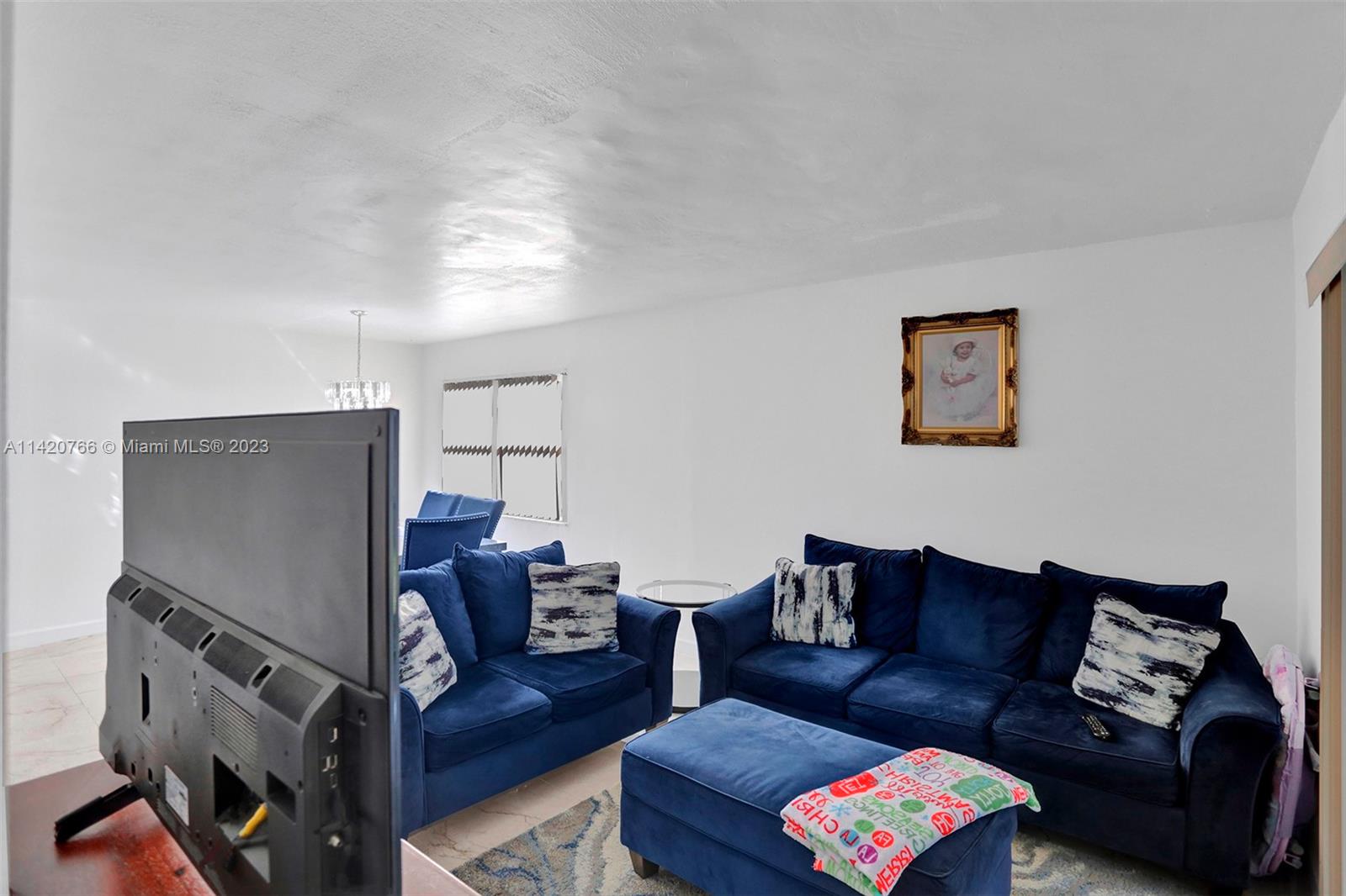 3410 Foxcroft Road, Unit 202 Miramar, FL 33025 - Photo 15 of 35 a living room with furniture and a flat screen tv