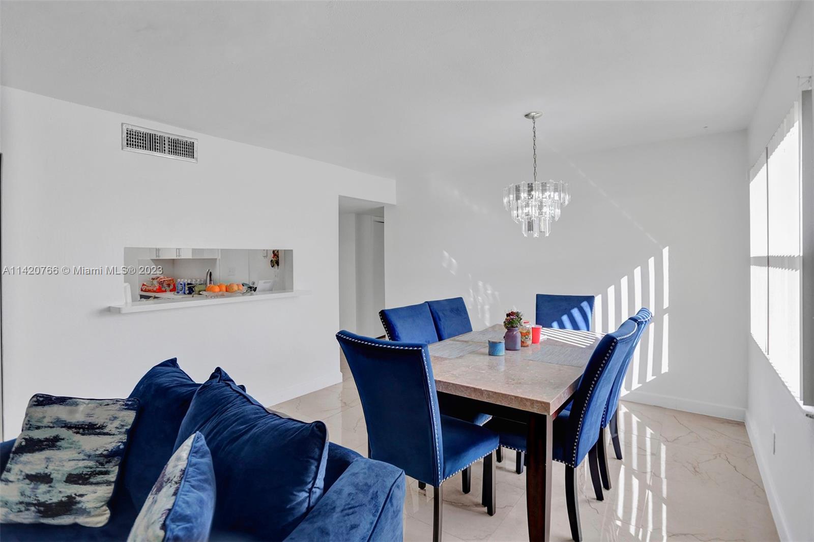 3410 Foxcroft Road, Unit 202 Miramar, FL 33025 - Photo 18 of 35 a living room with furniture and a chandelier
