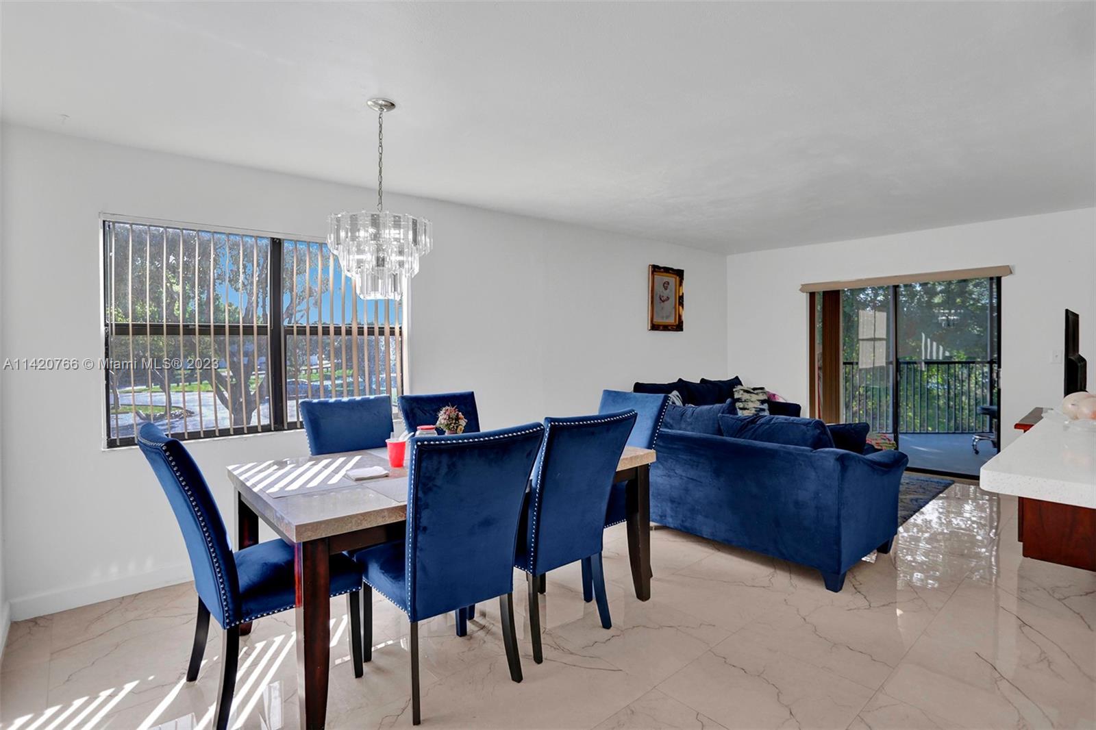 3410 Foxcroft Road, Unit 202 Miramar, FL 33025 - Photo 20 of 35 a view of a dining room with furniture window and wooden floor