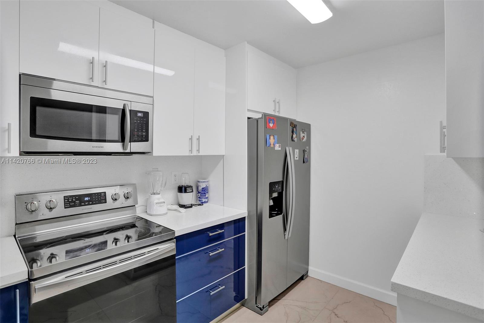3410 Foxcroft Road, Unit 202 Miramar, FL 33025 - Photo 2 of 35 a kitchen with stainless steel appliances a stove microwave and refrigerator