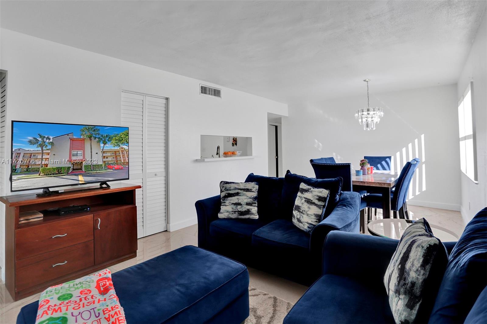 3410 Foxcroft Road, Unit 202 Miramar, FL 33025 - Photo 22 of 35 a living room with furniture and wooden floor