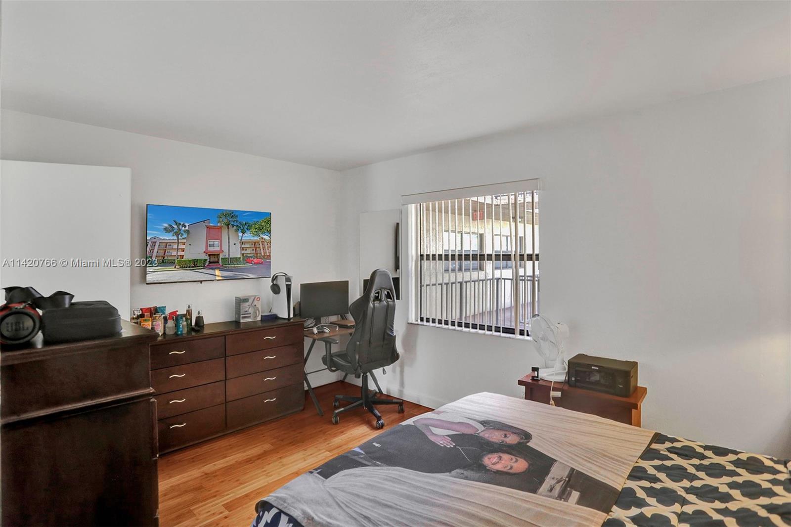 3410 Foxcroft Road, Unit 202 Miramar, FL 33025 - Photo 23 of 35 a bedroom with a bed and wooden floor
