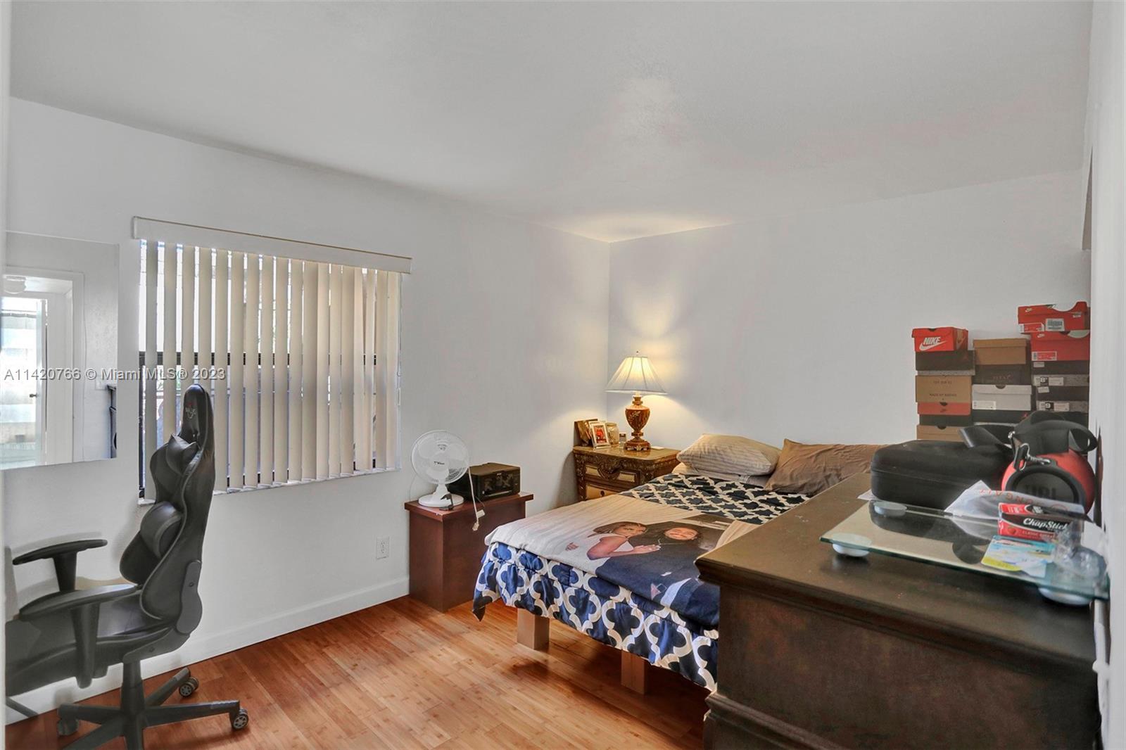 3410 Foxcroft Road, Unit 202 Miramar, FL 33025 - Photo 24 of 35 a bedroom with a bed and a chair