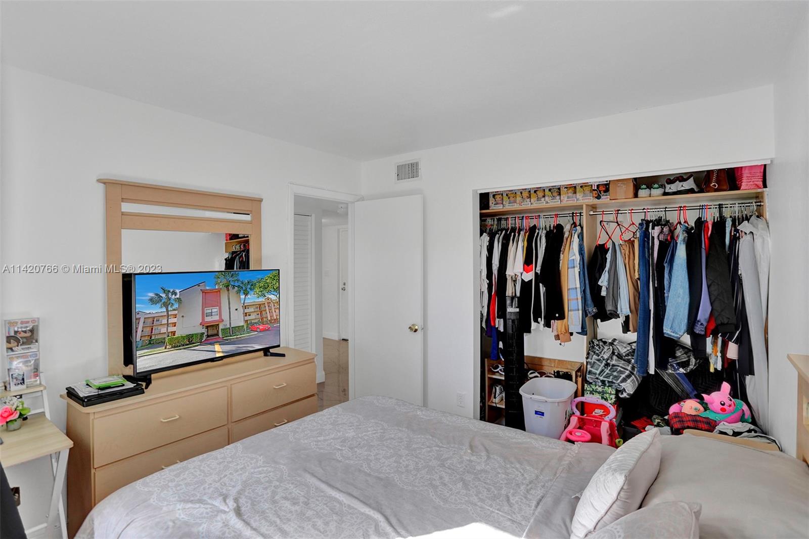 3410 Foxcroft Road, Unit 202 Miramar, FL 33025 - Photo 29 of 35 a bed room with a bed and a walk in closet