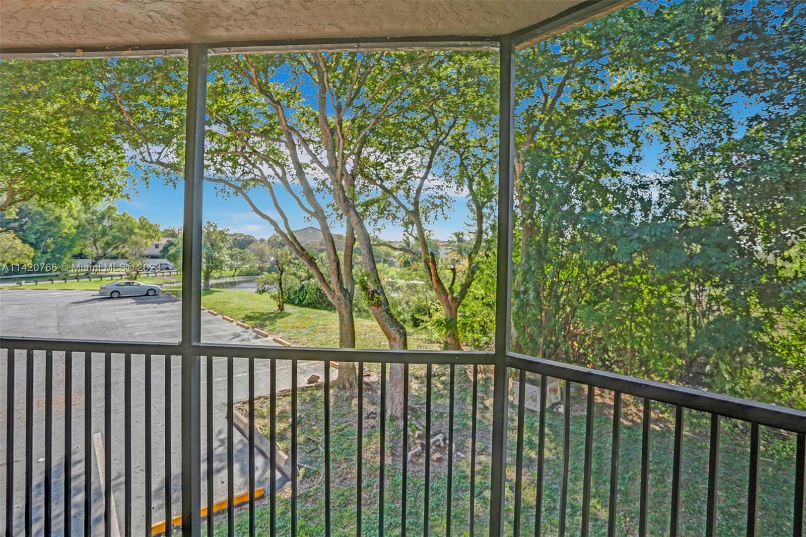 3410 Foxcroft Road, Unit 202 Miramar, FL 33025 - Photo 31 of 35 a view of a balcony with a trees