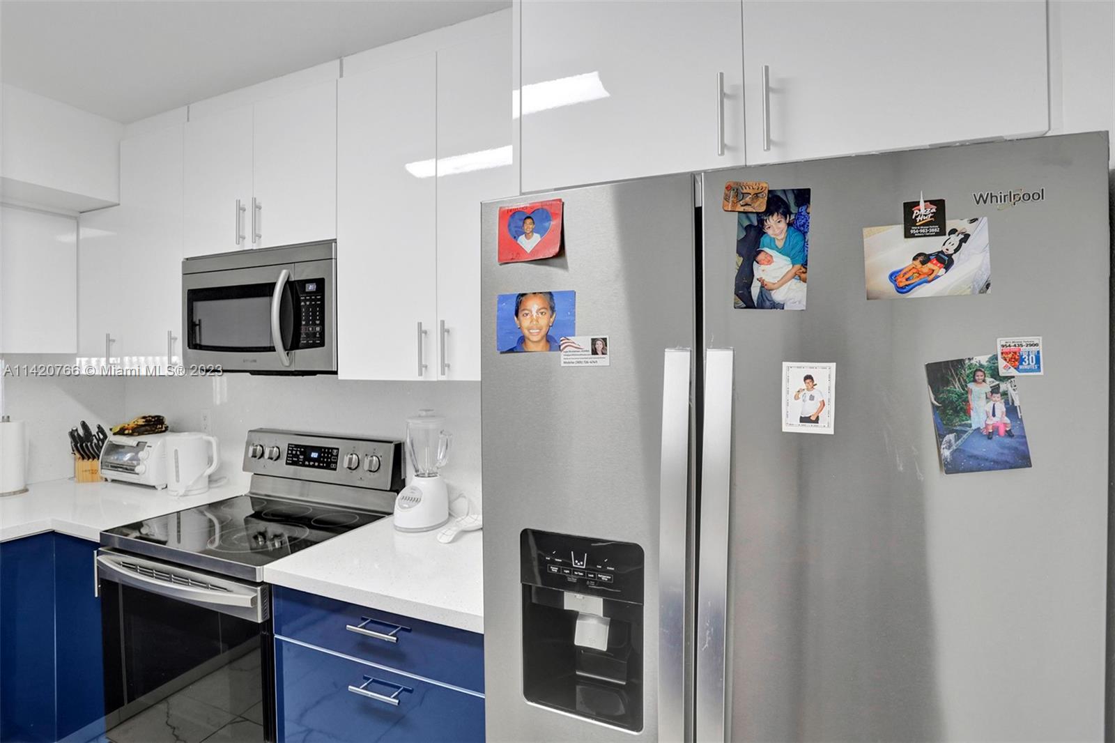 3410 Foxcroft Road, Unit 202 Miramar, FL 33025 - Photo 4 of 35 a kitchen with stainless steel appliances granite countertop a refrigerator and a stove top oven