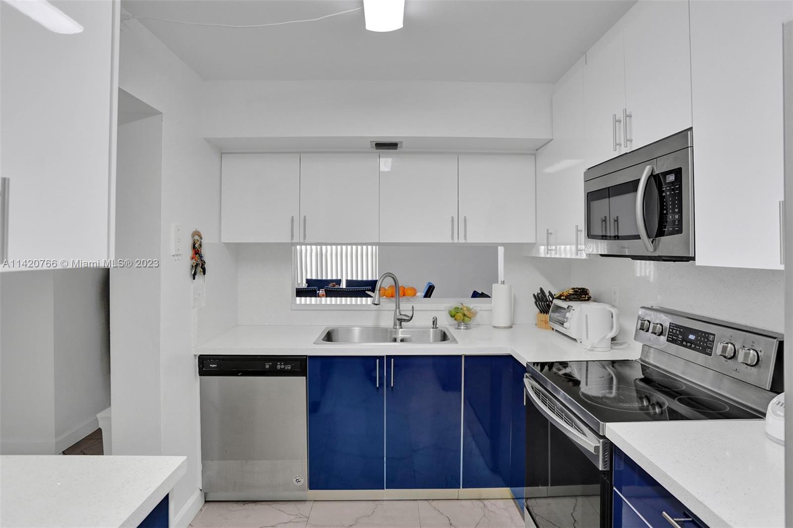 3410 Foxcroft Road, Unit 202 Miramar, FL 33025 - Photo 5 of 35 a kitchen with a sink a stove and cabinets