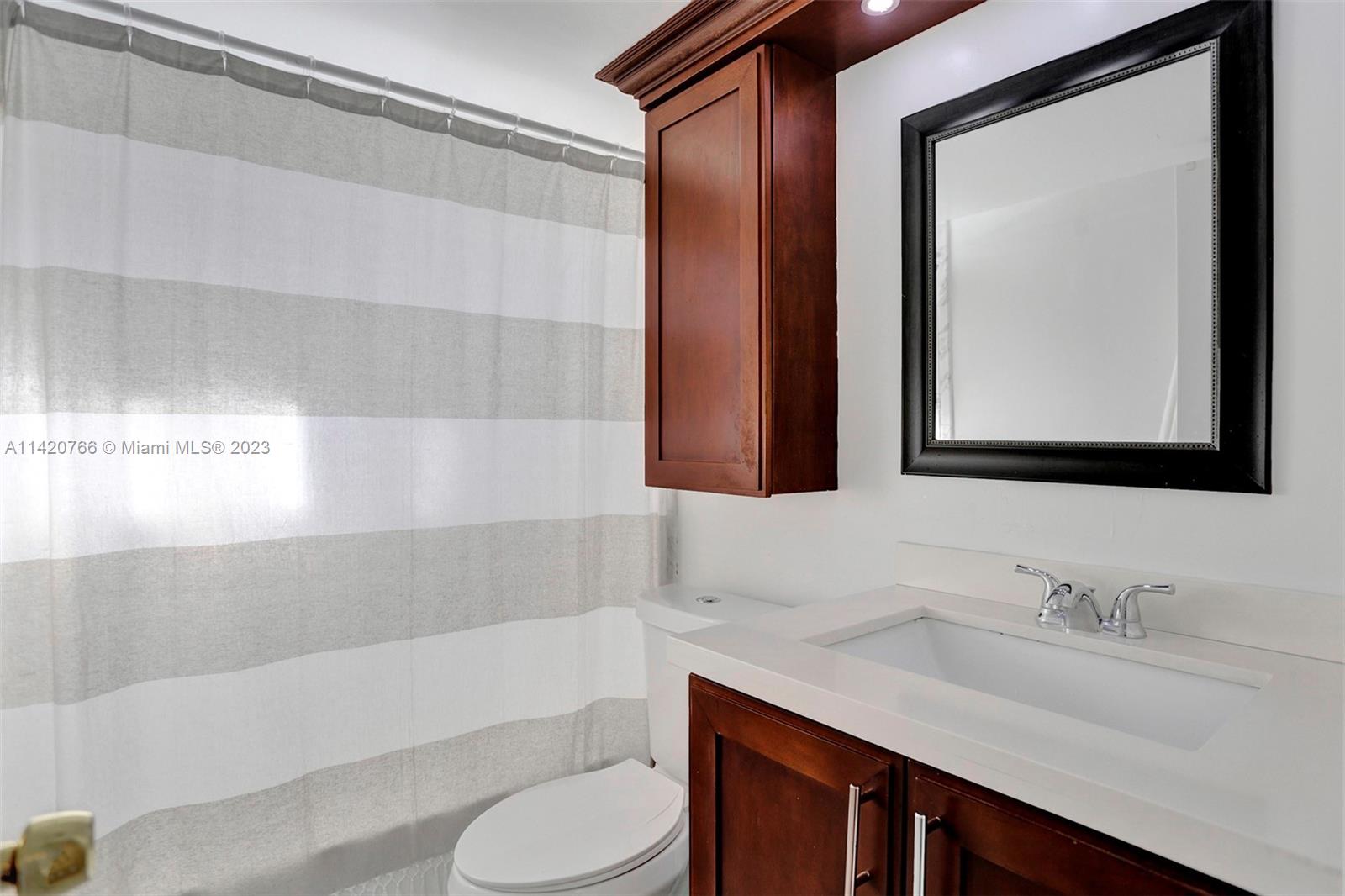 3410 Foxcroft Road, Unit 202 Miramar, FL 33025 - Photo 6 of 35 a bathroom with a granite countertop sink toilet and mirror