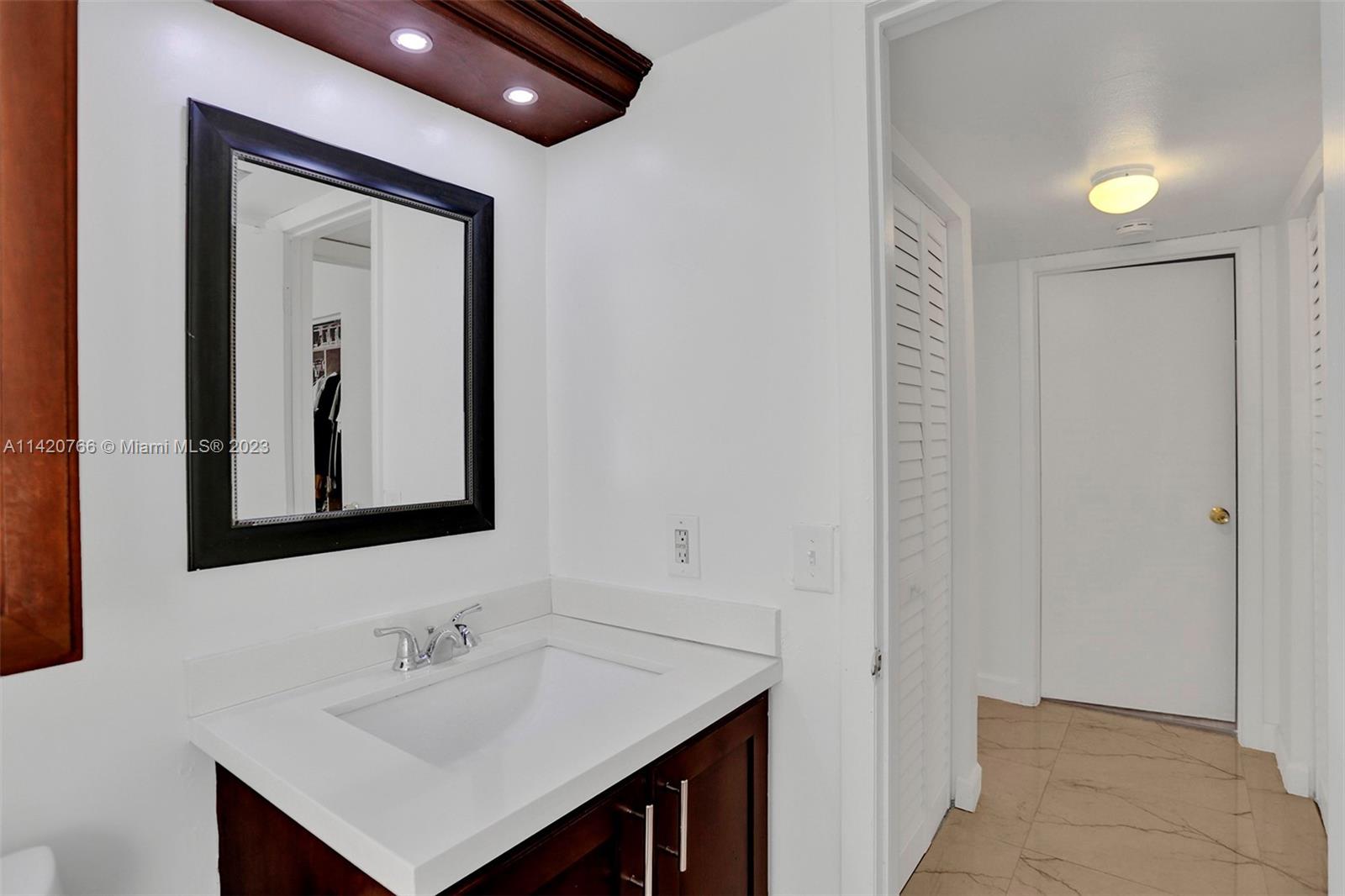 3410 Foxcroft Road, Unit 202 Miramar, FL 33025 - Photo 7 of 35 a bathroom with a sink and a mirror