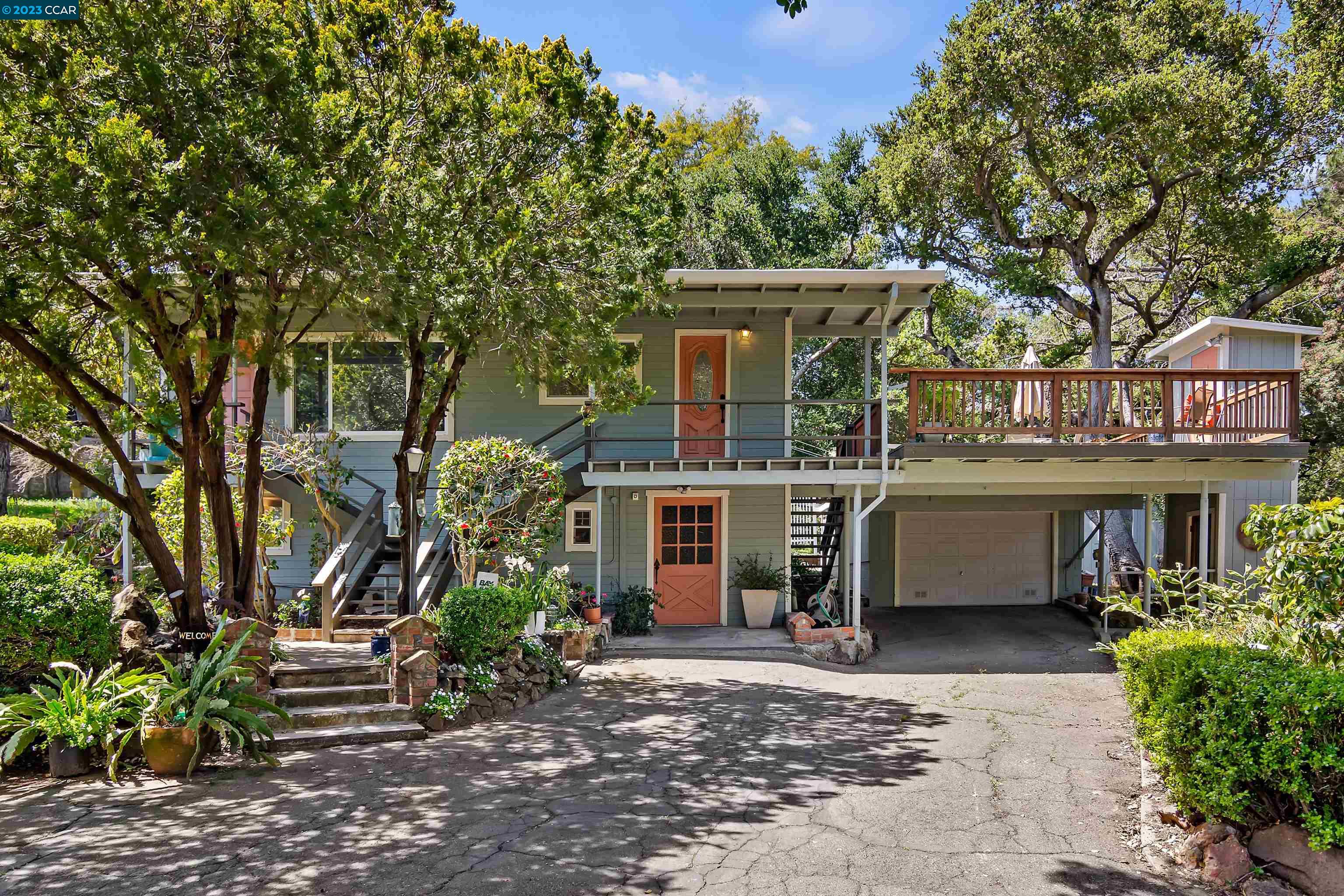 a front view of a house with a garden