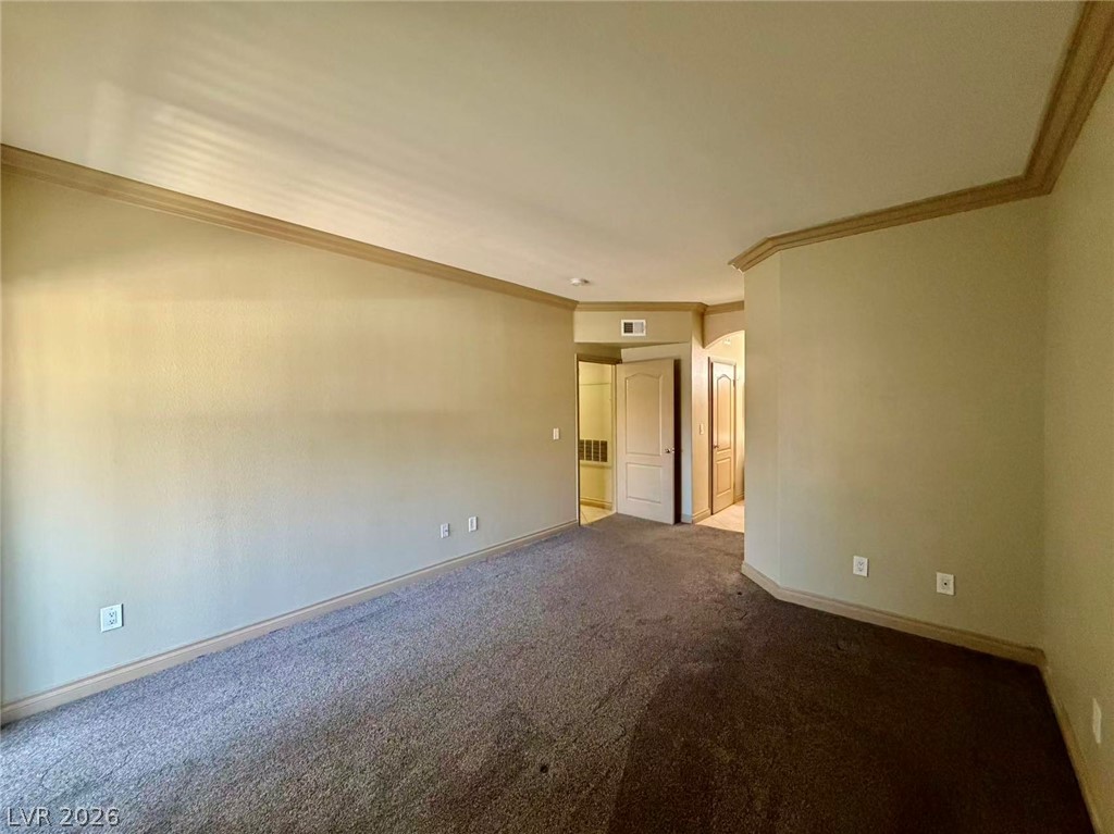 5525 West Flamingo Road, Unit 1019 Las Vegas, NV 89103 - Photo 15 of 18 A spacious room offers ample wall space for decor, complemented by comfortable carpeting.