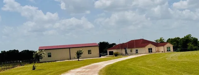 a front view of house with yard and trees
