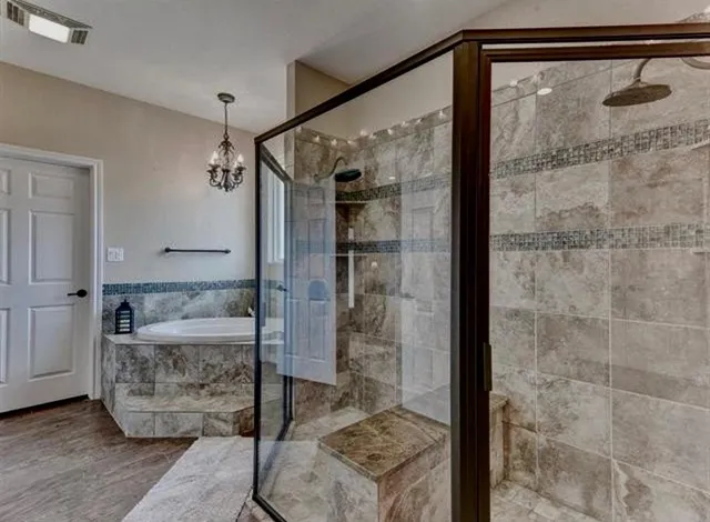 a bathroom with a shower and a mirror