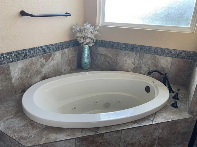a white bath tub sitting in a bathroom