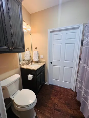 a bathroom with a sink a toilet and vanity