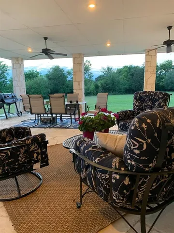 a living room with patio furniture and a fireplace