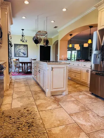a kitchen with stainless steel appliances kitchen island granite countertop a sink and cabinets