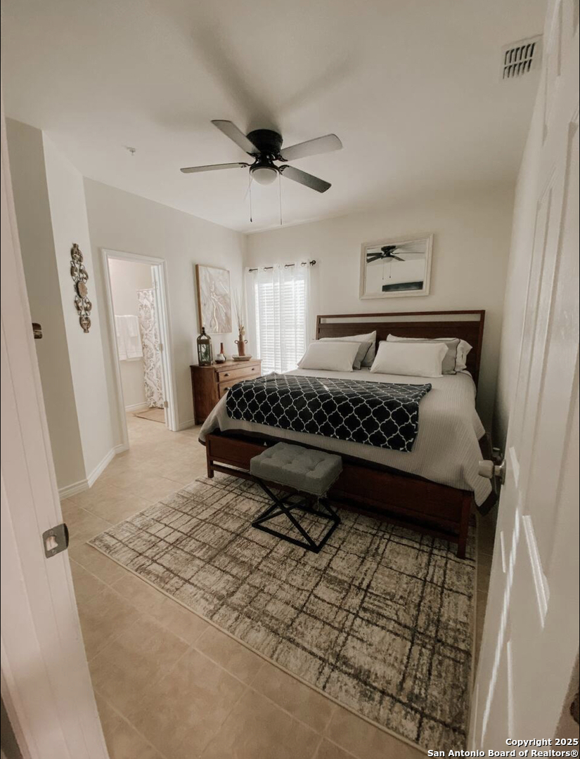 391 Riverside Drive, Unit 21 Eagle Pass, TX 78852 - Photo 9 of 11 a bed sitting in a bedroom next to a window