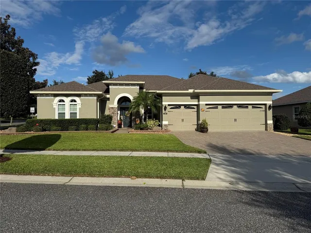 a front view of a house with a yard and garage