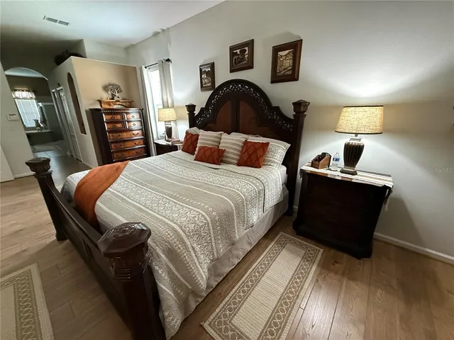 a bed sitting in a bedroom next to a window