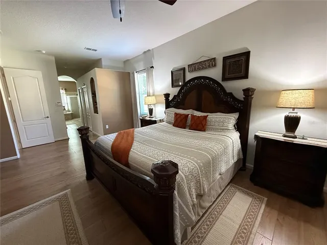 a bathroom with a sink a toilet a mirror and shower