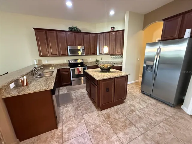 an empty room with closet and a ceiling fan