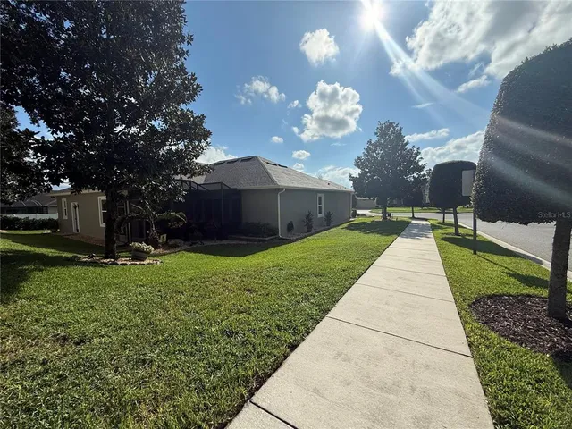 a backyard of a house with a garden and barbeque oven