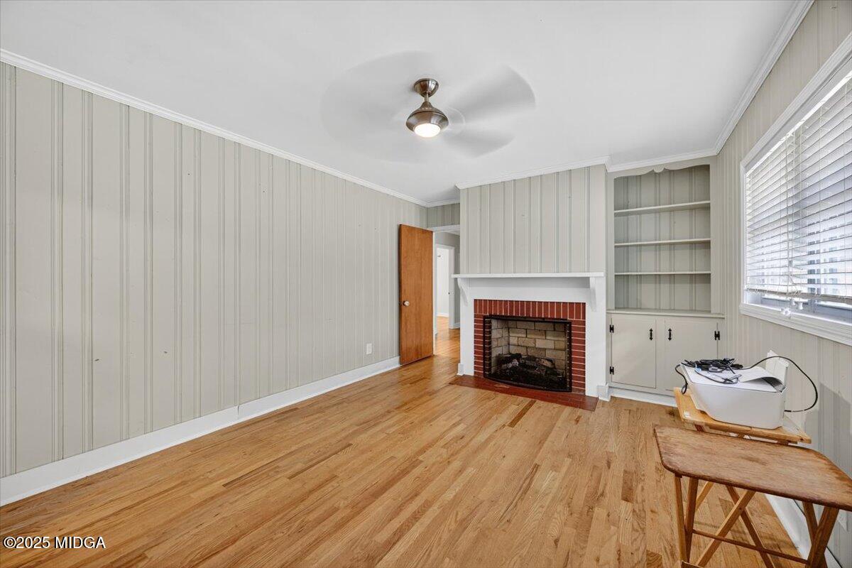 84 Hillsdale Road Forsyth, GA 31029 - Photo 11 of 27 a view of an empty room with wooden floor fireplace and a window
