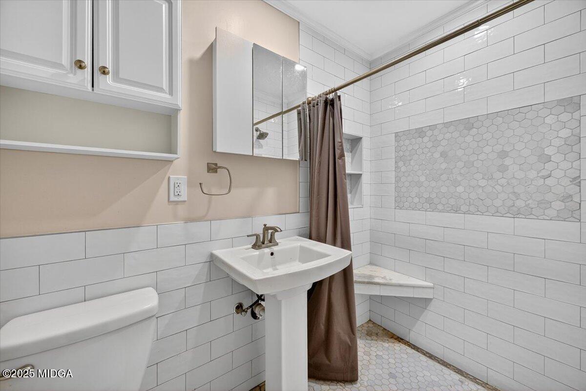 84 Hillsdale Road Forsyth, GA 31029 - Photo 16 of 27 a bathroom with a sink a toilet and mirror