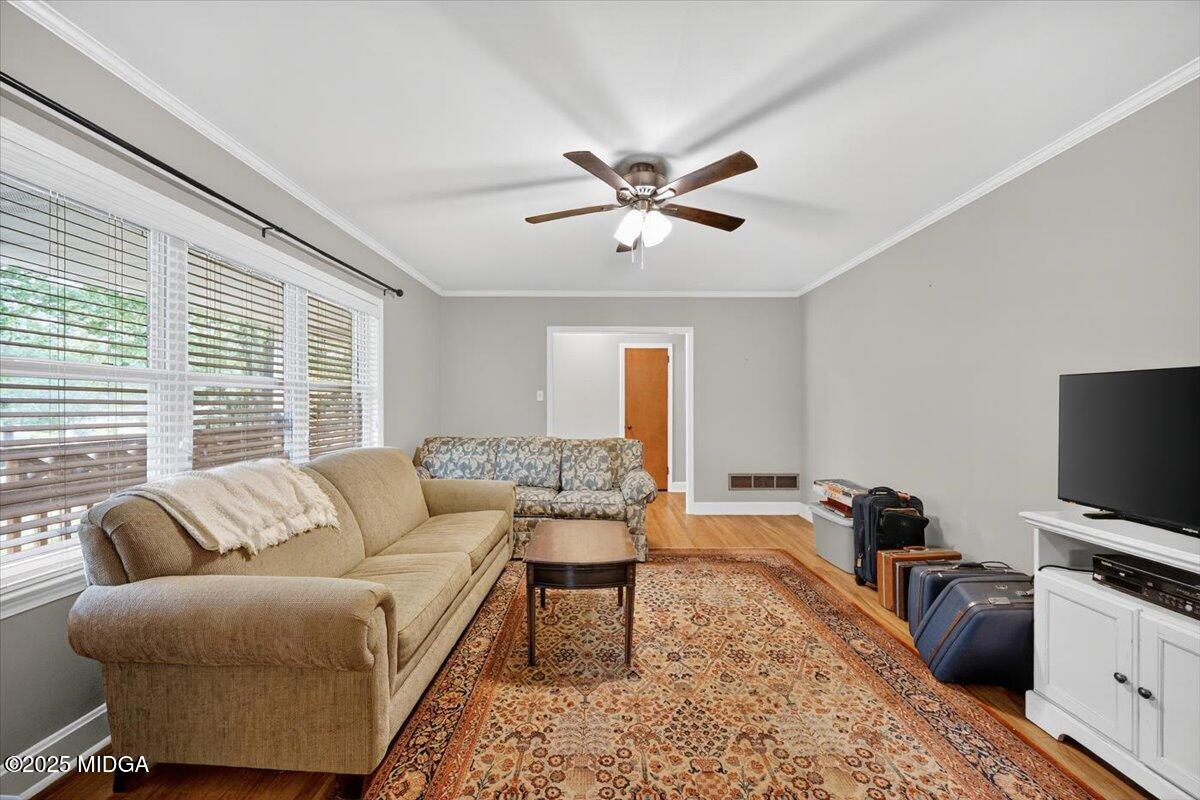 84 Hillsdale Road Forsyth, GA 31029 - Photo 18 of 27 a living room with furniture a ceiling fan and a window