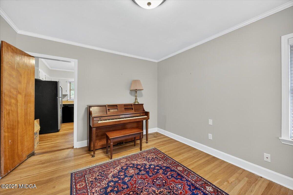 84 Hillsdale Road Forsyth, GA 31029 - Photo 20 of 27 a living room with a piano and a printer next to a window