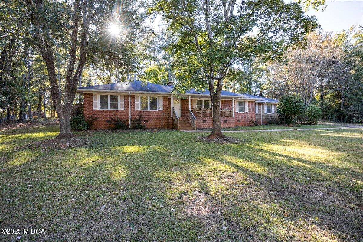84 Hillsdale Road Forsyth, GA 31029 - Photo 2 of 27 a view of a house with a yard and trees
