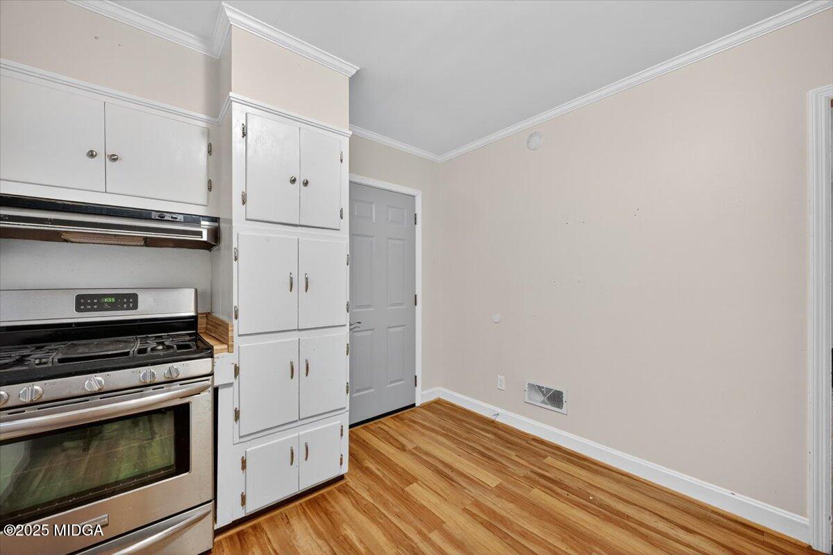 84 Hillsdale Road Forsyth, GA 31029 - Photo 8 of 27 a kitchen with wooden floor and white appliances