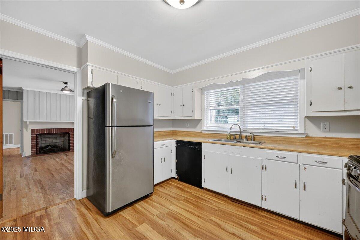 84 Hillsdale Road Forsyth, GA 31029 - Photo 9 of 27 a kitchen with a refrigerator a sink and cabinets