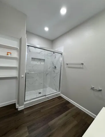 a bathroom with a glass shower door