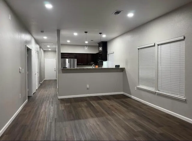 a view of a kitchen with a sink and a refrigerator
