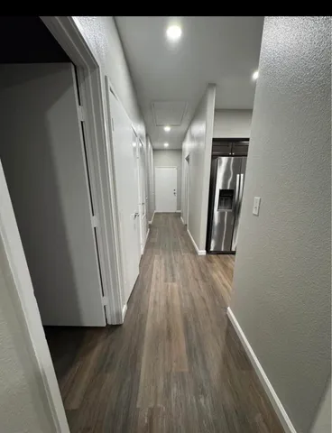 a view of gallery with wooden floor