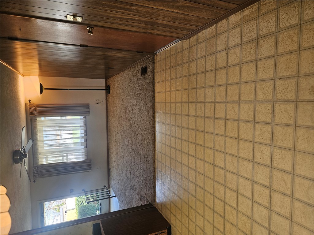 6510 Longford Road Dayton, OH 45424 - Photo 16 of 27 This interior space features classic tile and warm wood paneling, creating a cozy and inviting atmosphere.