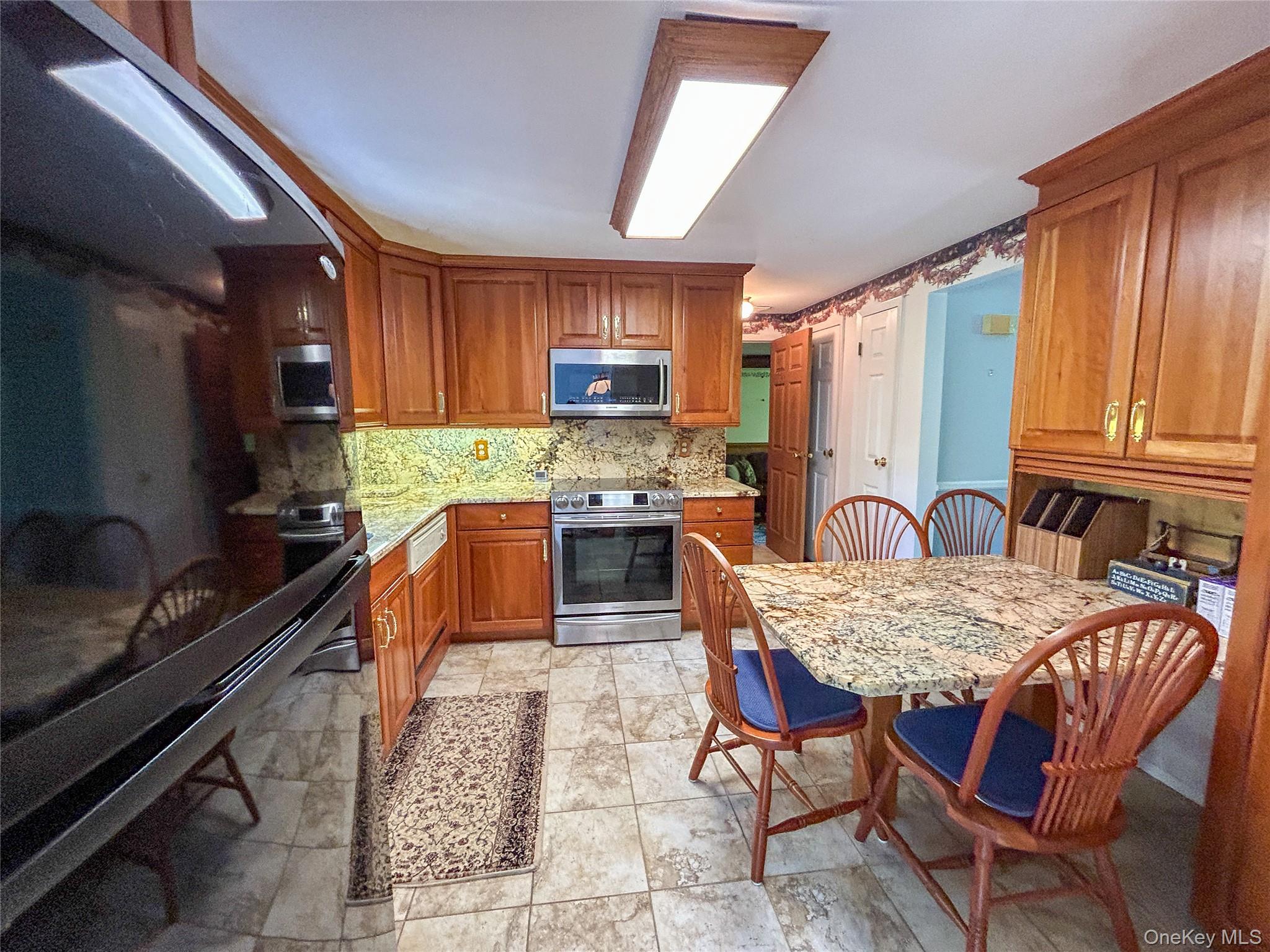 3 Johnston Road Livingston Manor, NY 12758 - Photo 18 of 43 a kitchen with a stove a sink and a refrigerator