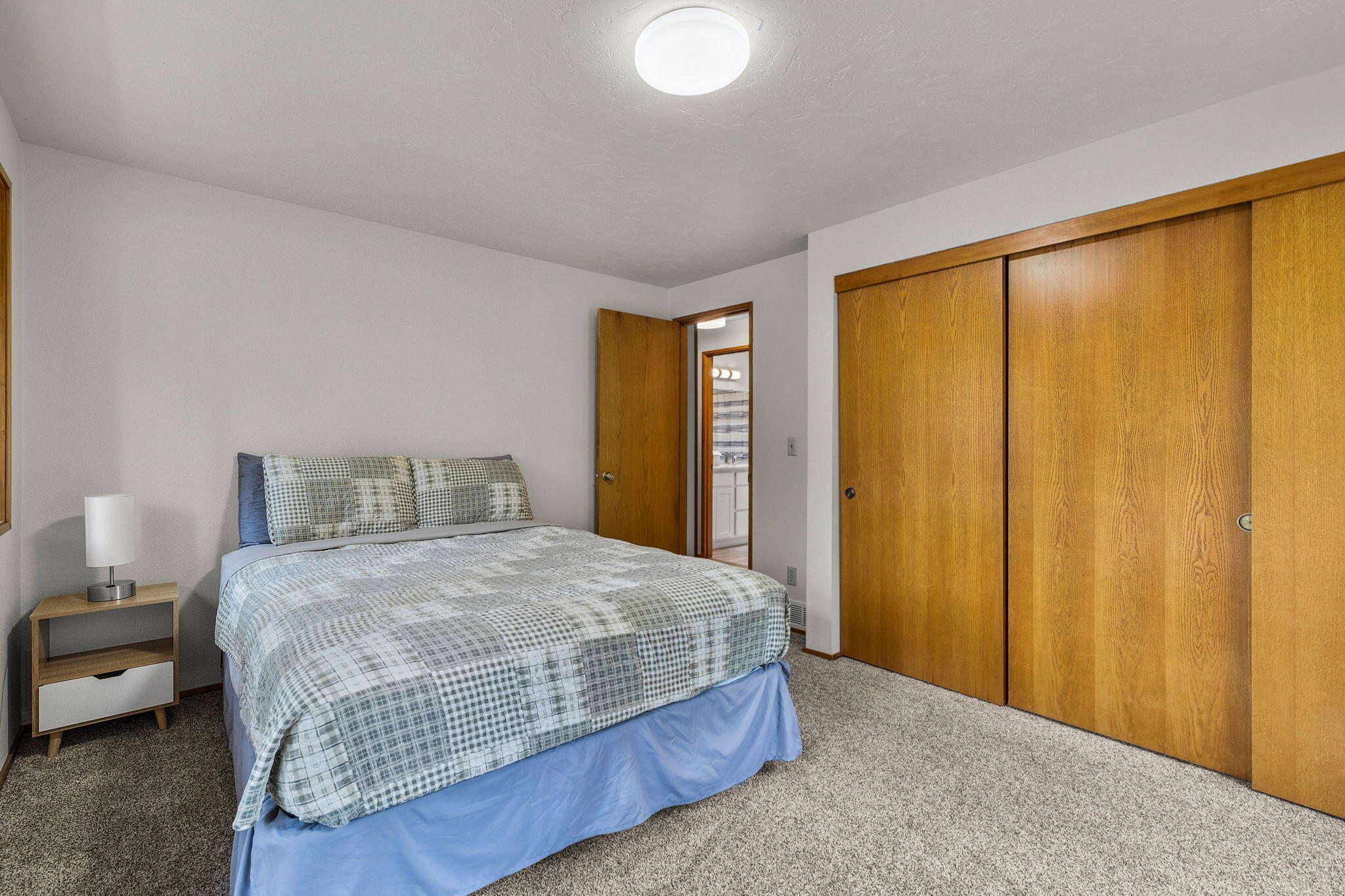 13168 Hawks Beard Black Butte Ranch, OR 97759 - Photo 33 of 47 a bedroom with a bed and large windows