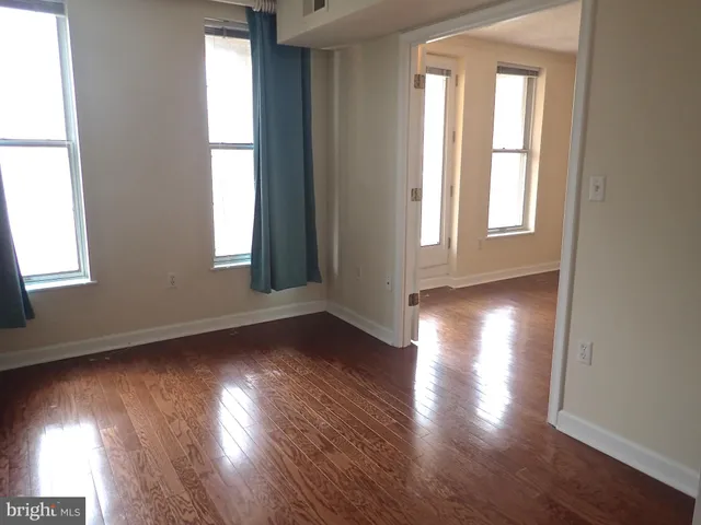 a very nice looking dining room with a large window and potted plants