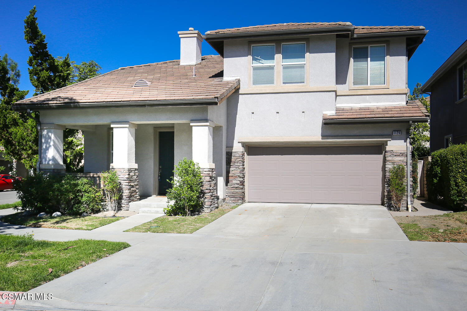 1129 Azalea Way Simi Valley, CA 93065 - Photo 1 of 50 a front view of a house with a yard and garage
